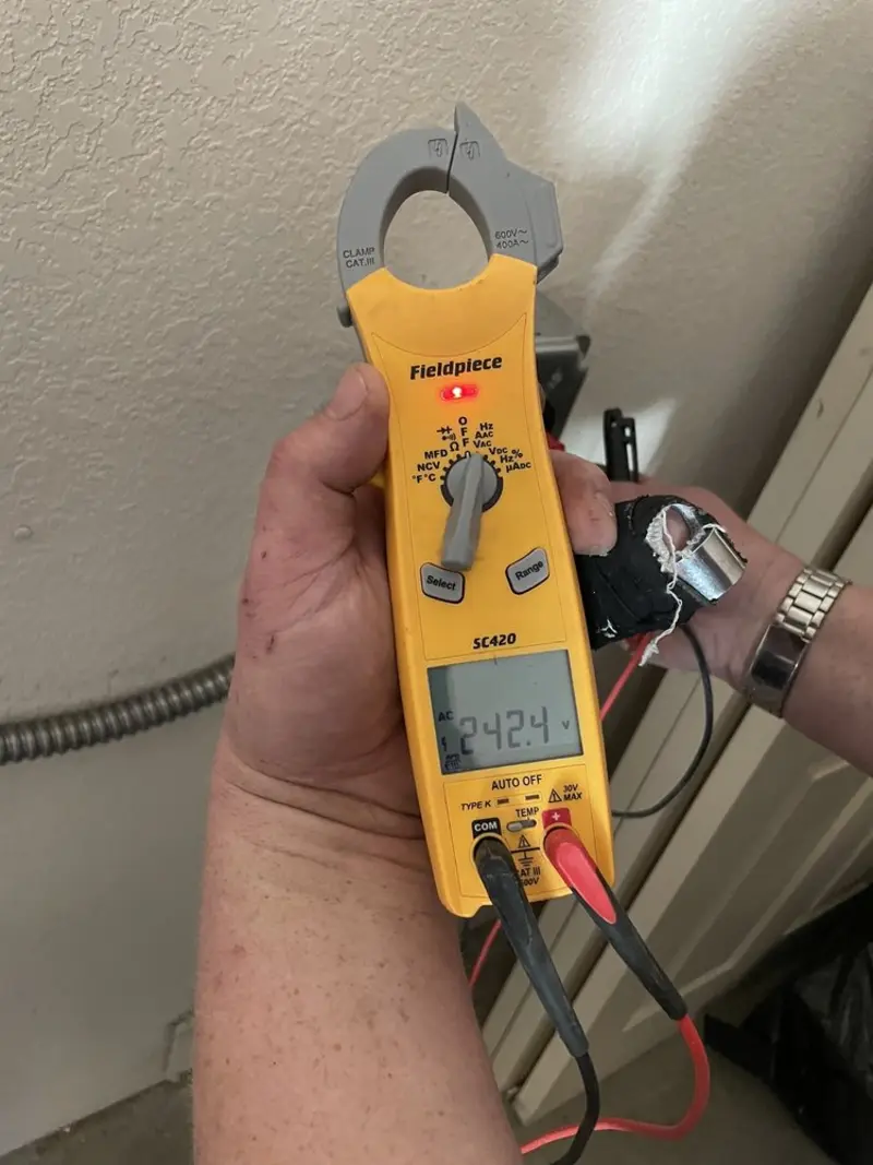 Voltage testing with clamp meter during Outlet Installation in Three Lakes